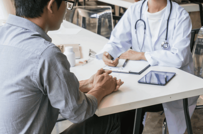 doctor giving diagnosis to patient over table, sarcoma awareness month